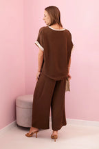 damskie spodnie z wiskozy w pudrowym różu ze złotym wykończeniem