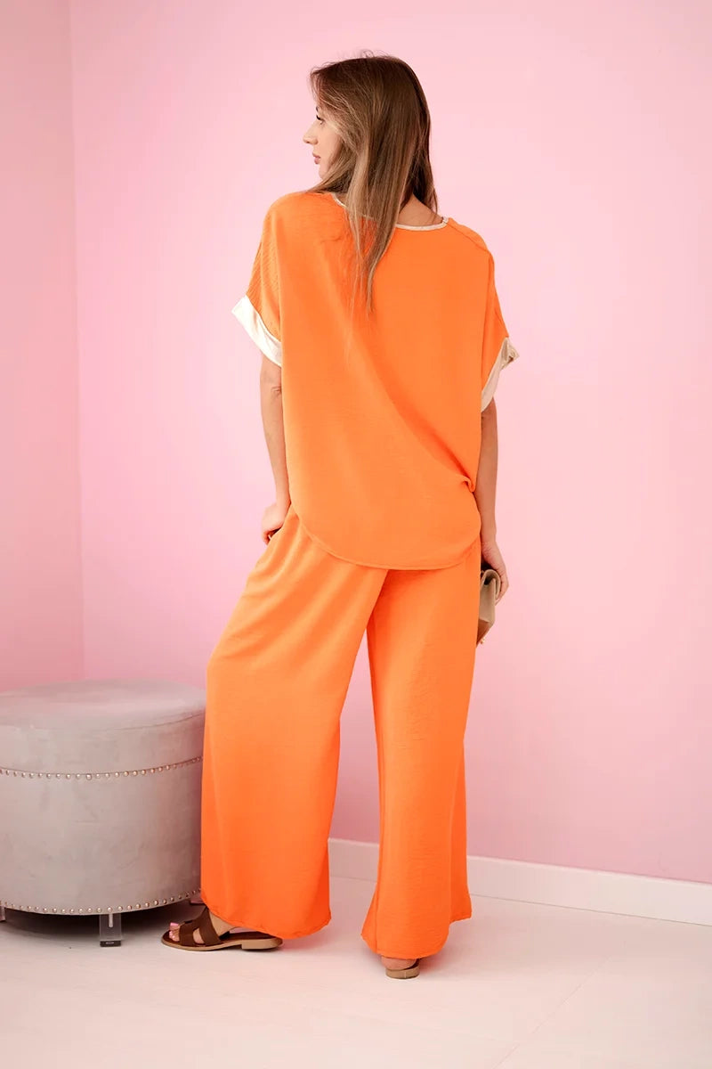 damskie ubrania z wiskozy w ciemnym pudrowyrożu ze złotymi elementami wykończenia