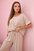 damskie spodnie ze złotym obszyciem w kolorze ciemnego pudrowego różu