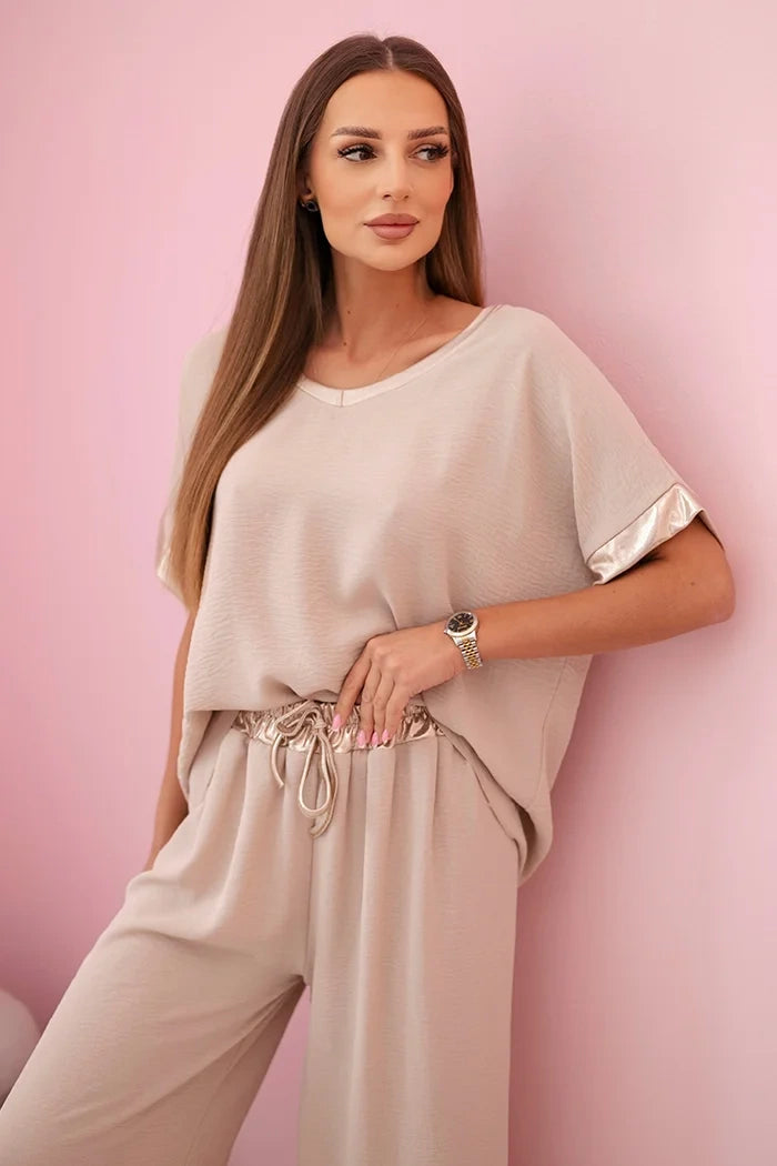 damskie spodnie ze złotym obszyciem w kolorze ciemnego pudrowego różu